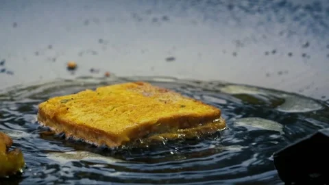Crispy Bread Slice Frying in Hot Oil Close-Up Stock Footage 323098716