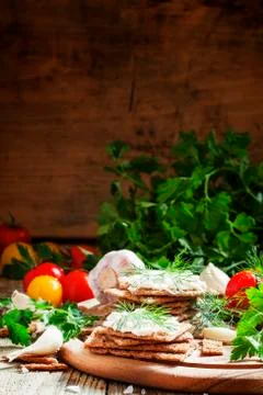 Crispy bread with soft cheese and herbs, selective focus Stock Photos