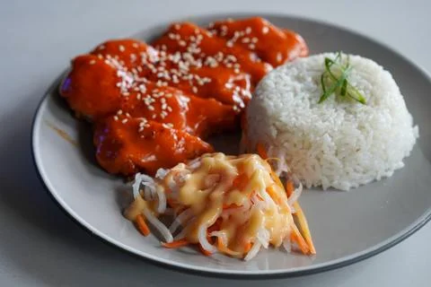 Crispy breaded chicken cutlet topped with creamy mentaiko sauce Stock Photos