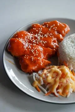 Crispy breaded chicken cutlet topped with creamy mentaiko sauce Foto stock