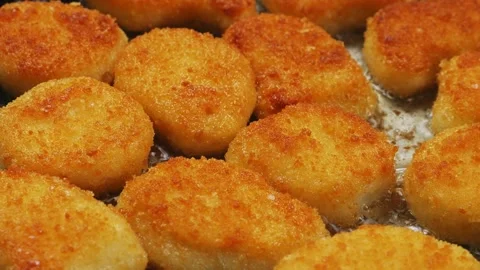 Crispy breaded chicken nuggets are fried in a frying pan in boiling oil. Cl.. Stock Footage 296908929