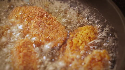 Crispy Breaded Chicken Nuggets Are Fried In A Frying Pan. Close Up Stock Footage 313127208