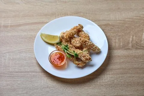 Crispy breaded chicken strips with dipping sauce Stock Photos