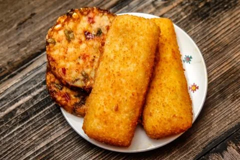 Crispy breaded fried fish fillet and vegetarian burger Stock Photos