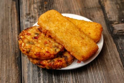 Crispy breaded fried fish fillet and vegetarian burger Stock Photos