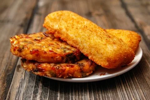 Crispy breaded fried fish fillet and vegetarian burger Stock Photos