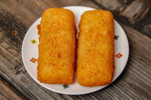 Crispy breaded fried hake fish fillet Stock Photos