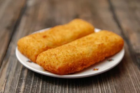 Crispy breaded fried hake fish fillet Stock Photos