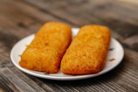 Crispy breaded fried hake fish fillet Stock Photos