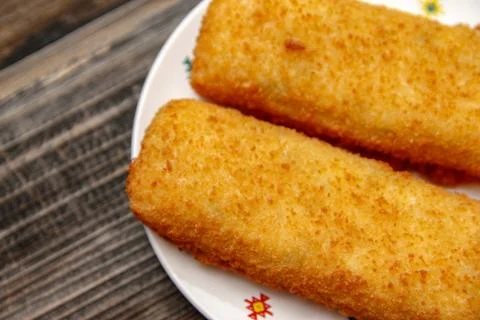 Crispy breaded fried hake fish fillet Stock Photos