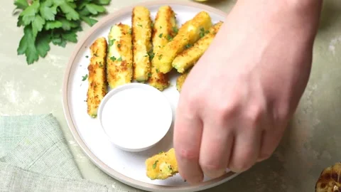 Crispy breaded zucchini sticks with white dipping sauce. Healthy eating. Stock Footage 322729306