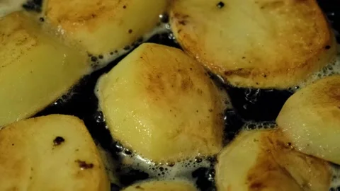 Crispy brown potatoes are fried in a frying pan. Flavorful home-cooked food Stock Footage 138988431