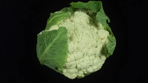Crispy Cauliflower With Leaves On Black Background. Stock Footage 312236353