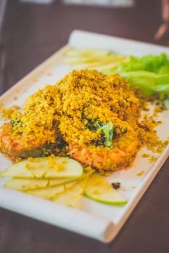 Crispy Cereal Prawn with fried basil leaves and apple slices on the side Stock Photos
