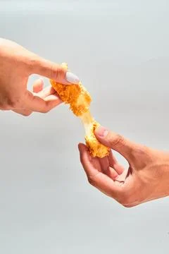 Crispy cheese fried breaded mozzarella cheese sticks stretch two hands Stock Photos