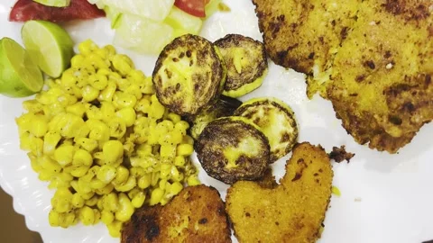 Crispy chicken cutlet with grilled zucchini and corn, top view close-up Stock Footage 345166392