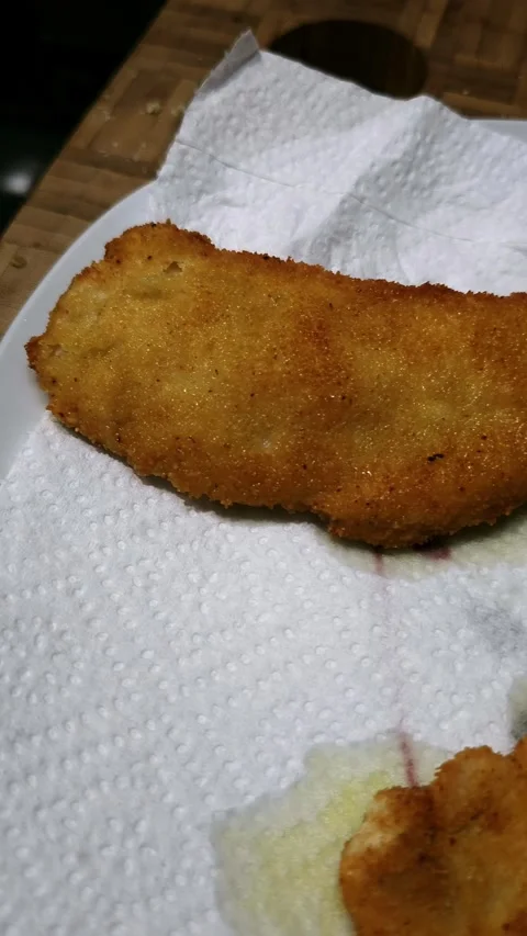Crispy chicken fillets resting on absorbent paper. Stock Footage 344858055
