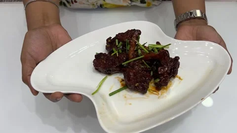 Crispy chilli chicken drum stick prepared with schezwan sauce in India. Stock Footage 310867492