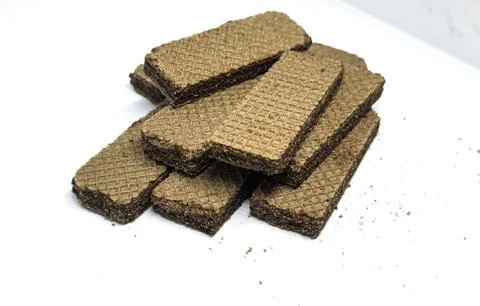 Crispy chocolate wafer biscuits neatly stacked on a wooden plate Stock Photos