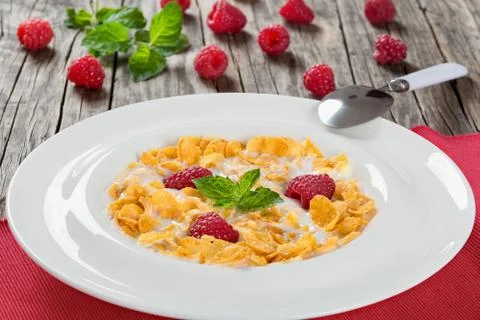 Crispy corn flakes with raspberry and cold milk Stock Photos