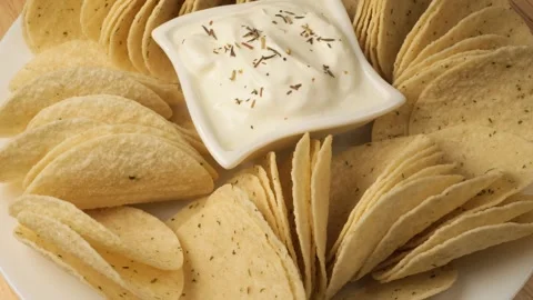 Crispy corn tortilla chips with dip rotating Stock Footage 343434321