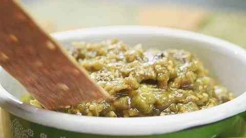 Crispy cracker is dipped in roasted eggplant and green pepper dip. 스톡 동영상 169798418