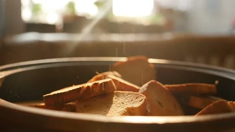 Crispy crackers in slow motion against a window. Sunlight. Close-up Stock Footage 144393005