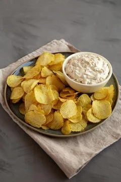 Crispy Crinkle Potato Chips and French Onion Dip on a Plate, side view. Stock Photos