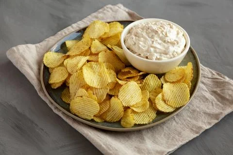 Crispy Crinkle Potato Chips and French Onion Dip on a Plate, side view. Stock Photos
