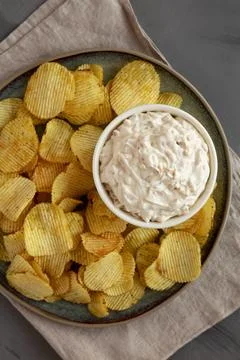 Crispy Crinkle Potato Chips and French Onion Dip on a Plate, top view. Flat.. Stock Photos