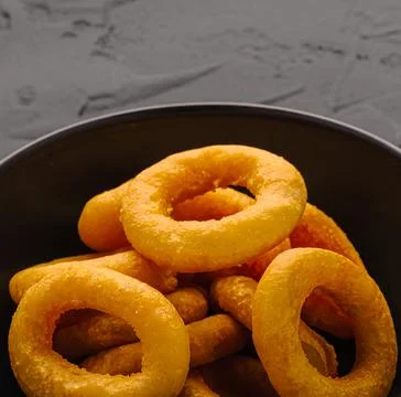 Crispy deep fried onion rings in bowl Stock Photos