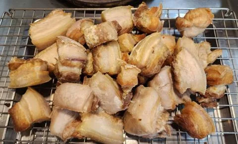 Crispy Deep Fried Pork Belly Chunks Resting on a Metal Cooling Rack Stock Photos