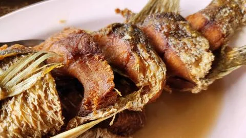Crispy Deep Fried Whole Fish with Savory Sauce - Traditional Thai Seafood C.. Stock Photos