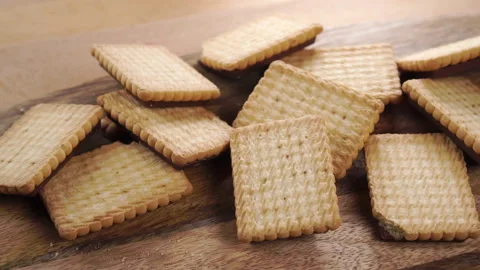Crispy delicious baked cookies with a pattern. Falling treats in a pile on a  Stock Footage 161154567