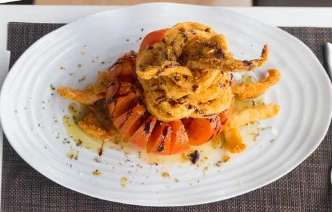 Crispy delicious fried squids served in a local restaurant Stock Photos