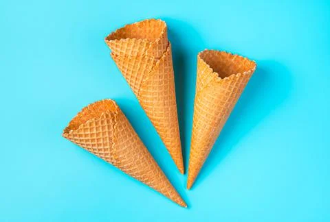 Crispy empty ice cream cones on a light blue background. Stockfoto's