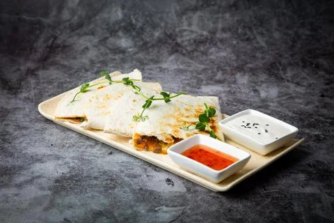 Crispy flatbreads stuffed with meat, herbs, lime and two sauces, side view Stock Photos