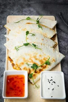 Crispy flatbreads stuffed with meat, herbs, lime and two sauces, side view Stock Photos