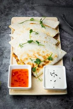 Crispy flatbreads stuffed with meat, herbs, lime and two sauces, side view Stock Photos