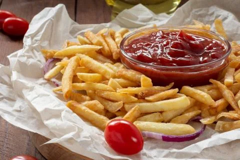 Crispy French fries on a ketchup Board Stock Photos