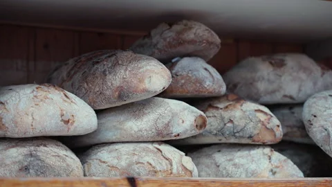 Crispy freshly baked bread loaves on wooden shelves in local bakery store, whole Video stock 257886148