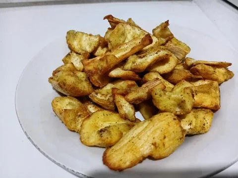 Crispy fried cassava chips served on a plate 库存照片