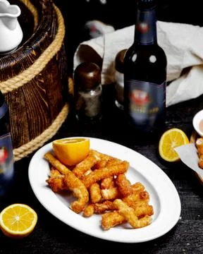 Crispy fried cheese served with lemon Stock Photos