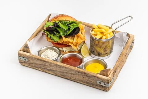 Crispy fried chicken burger served with fries and creamy dips Stock Photos