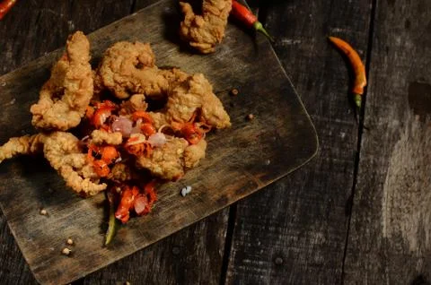 Crispy fried chicken chunks and sambal matah bali on wood table Stock Photos