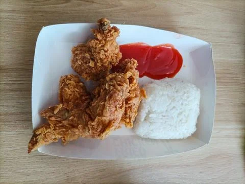 Crispy fried chicken served with white rice and chili sauce in Stock Photos
