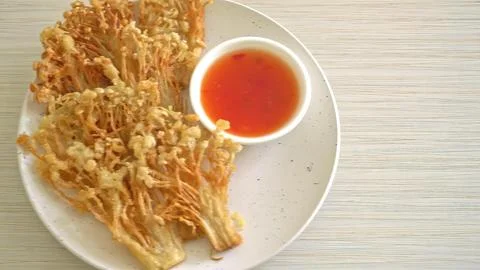 Crispy fried chicken strips with red dipping sauce on white plate Stock Photos