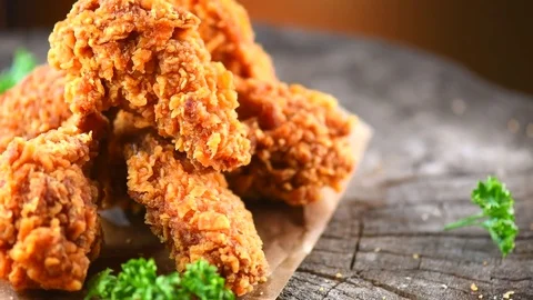 Crispy fried chicken wings and legs over wooden background Stock Footage 81486616