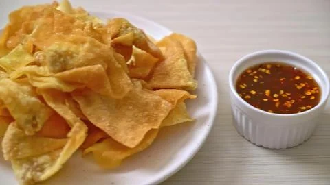 Crispy fried chips with spicy dipping sauce on a white plate Stock Photos