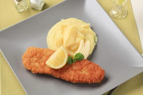 Crispy fried fish with lemon and mashed potatoes Stock Photos
